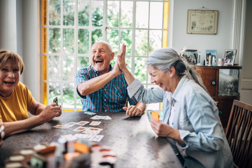 Senior people playing cards in nursing home